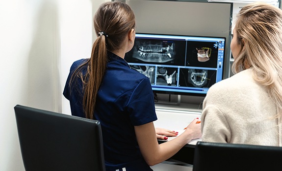 Team members looking at digital dental x-rays