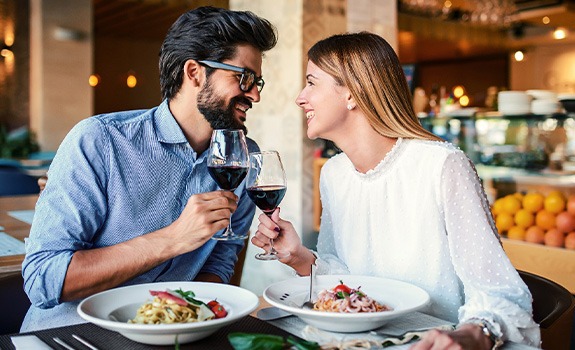 Couple smiling at each other on date in restaurant