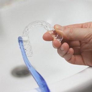 Cleaning clear aligner with toothbrush