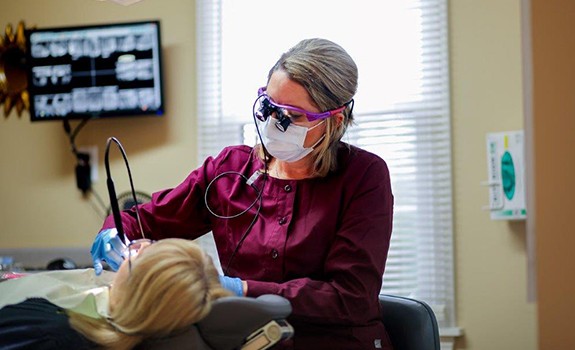 Dental team member treating dentistry patient