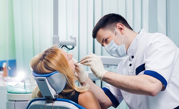 Dentist examining a woman’s mouth