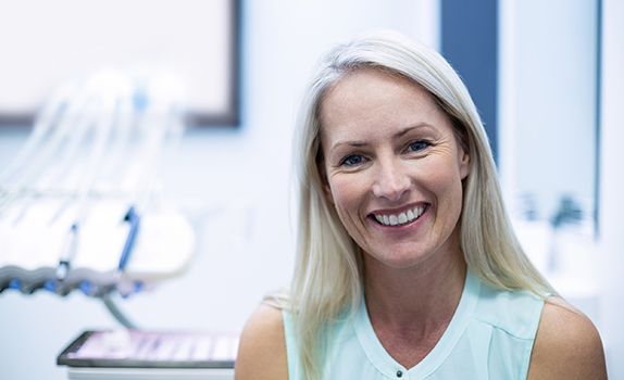 Woman in dental office smiling