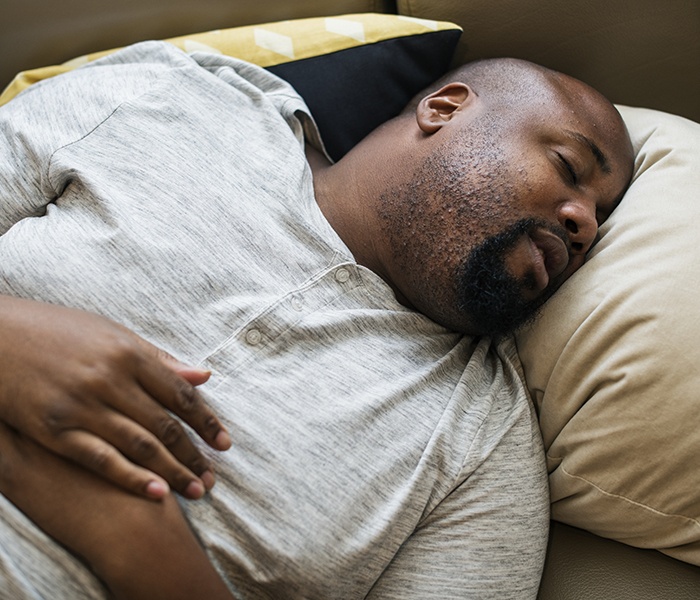Man resting peacefully after sleep apnea treatment