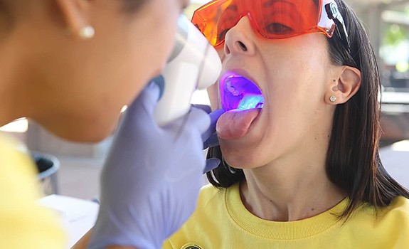 Dentist performing oral cancer screening