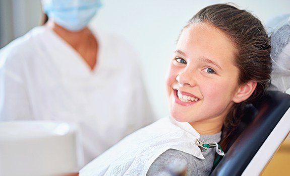 Child smiling after fluoride treatment