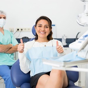 Happy patient giving two thumbs up