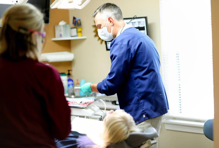 Doctor Saint Clair and dental team member treating dental patient