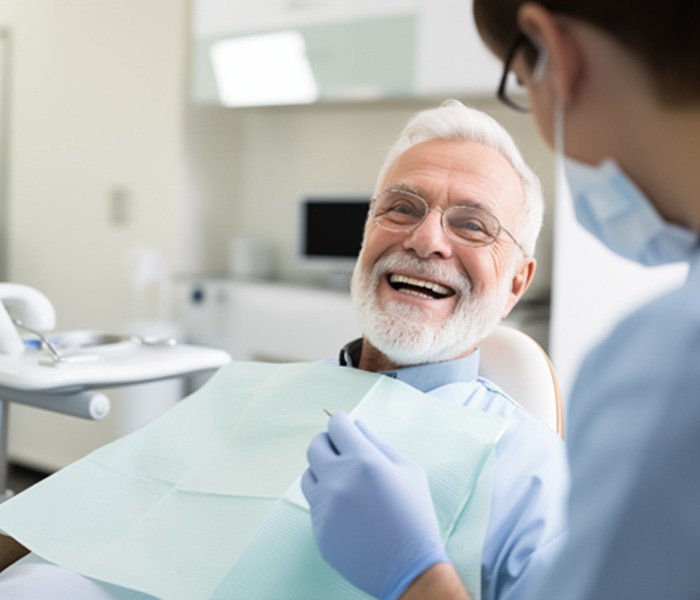Male patient preparing for an oral cancer screening in Rowley 