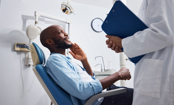 Dentist and patient discussing oral cancer screening 