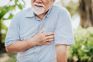 Man with hear disease holding chest