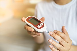 Person with diabetes checking blood sugar levels