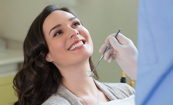 Woman smiling during routine periodontal maintenance visit