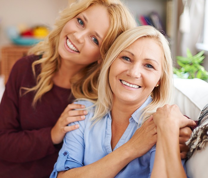 Two women smiling after porcelain veneers treatment