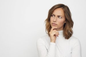 Patient thinking about the difference between veneers and bonding