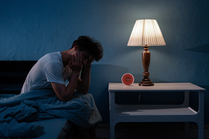 Man in bed who just woke up from a nightmare